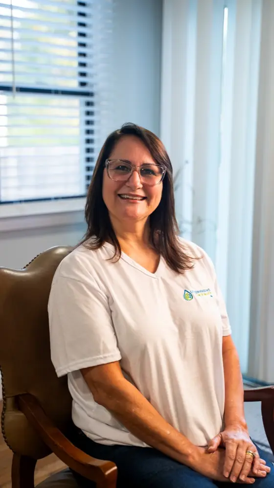 LL Cleaning team member seated in a leather chair, smiling