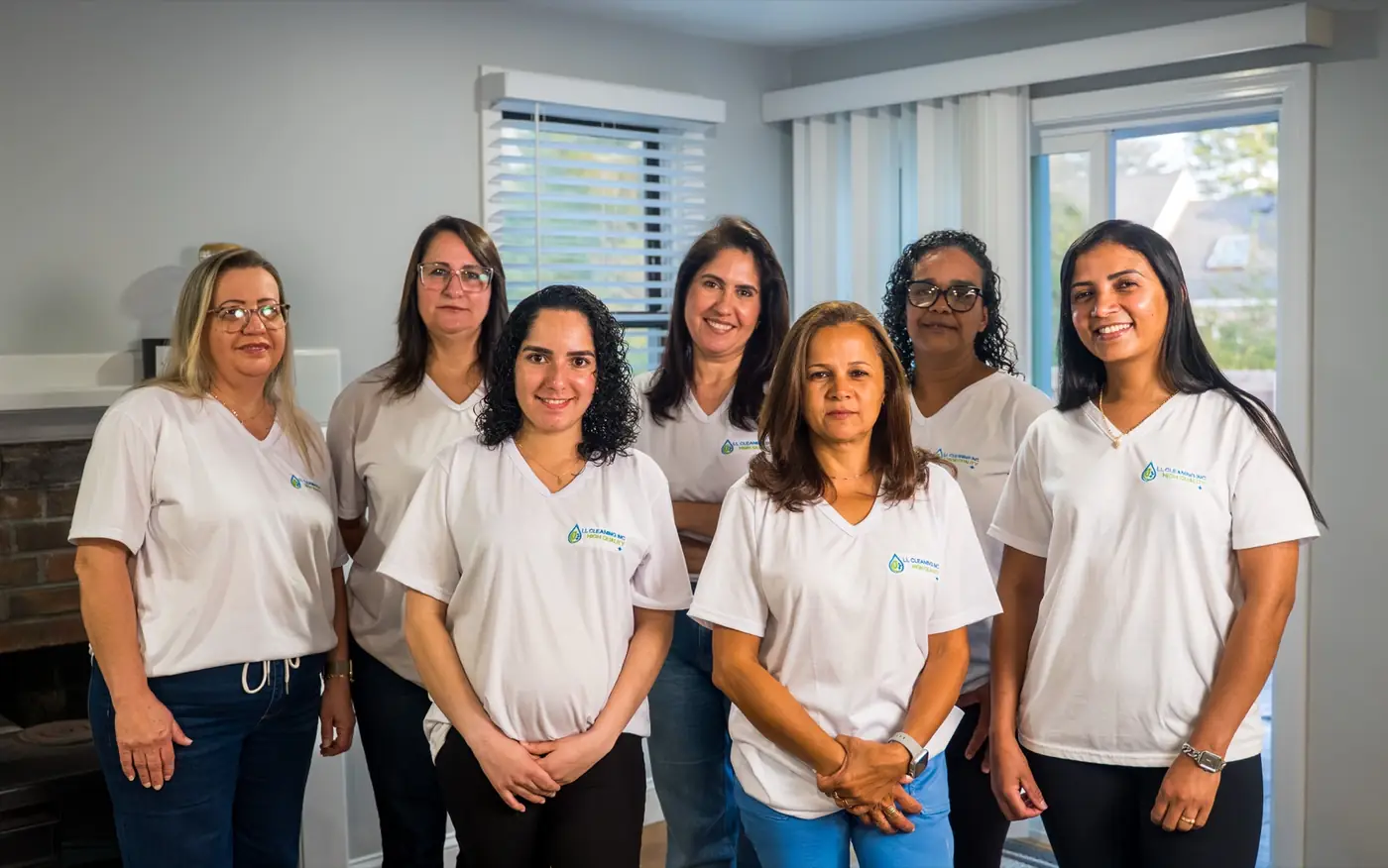The LL Cleaning team standing together in matching white uniform shirts